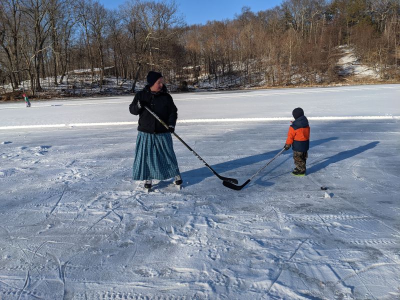 Anita Playing Hockey With a Small Friend