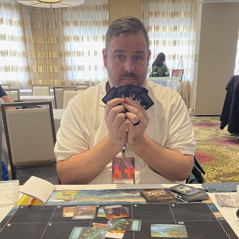 Greg Playing Card Games at a Gaming Convention