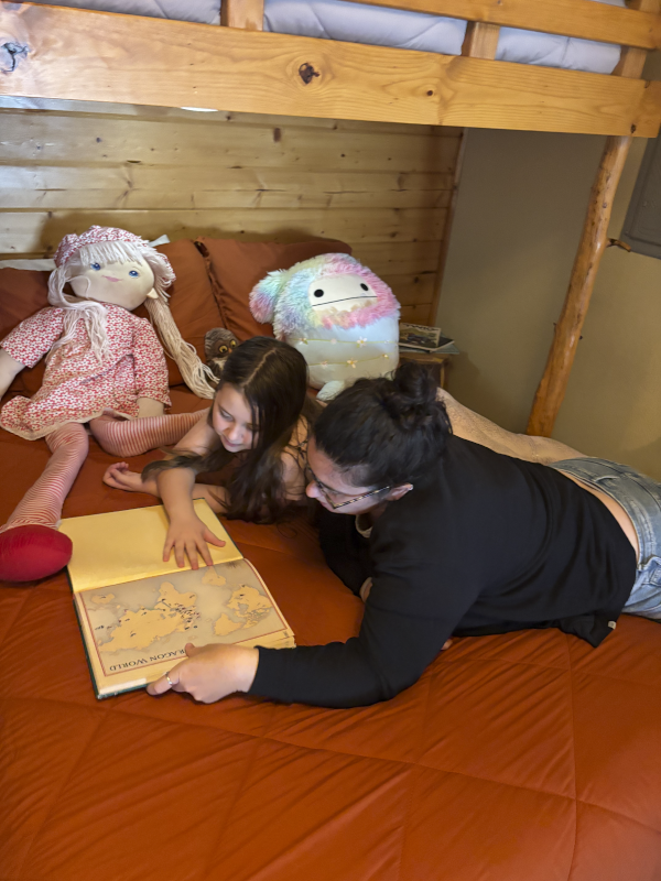 Emma and Autumn Reading a Book About Dragons